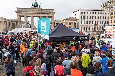 Berliner Neujahrslauf 2020: Ausgabe der Teilnehmernummern im Zelt von SCC Events im Startareal vorm Brandenburger Tor © SCC EVENTS/Camera4