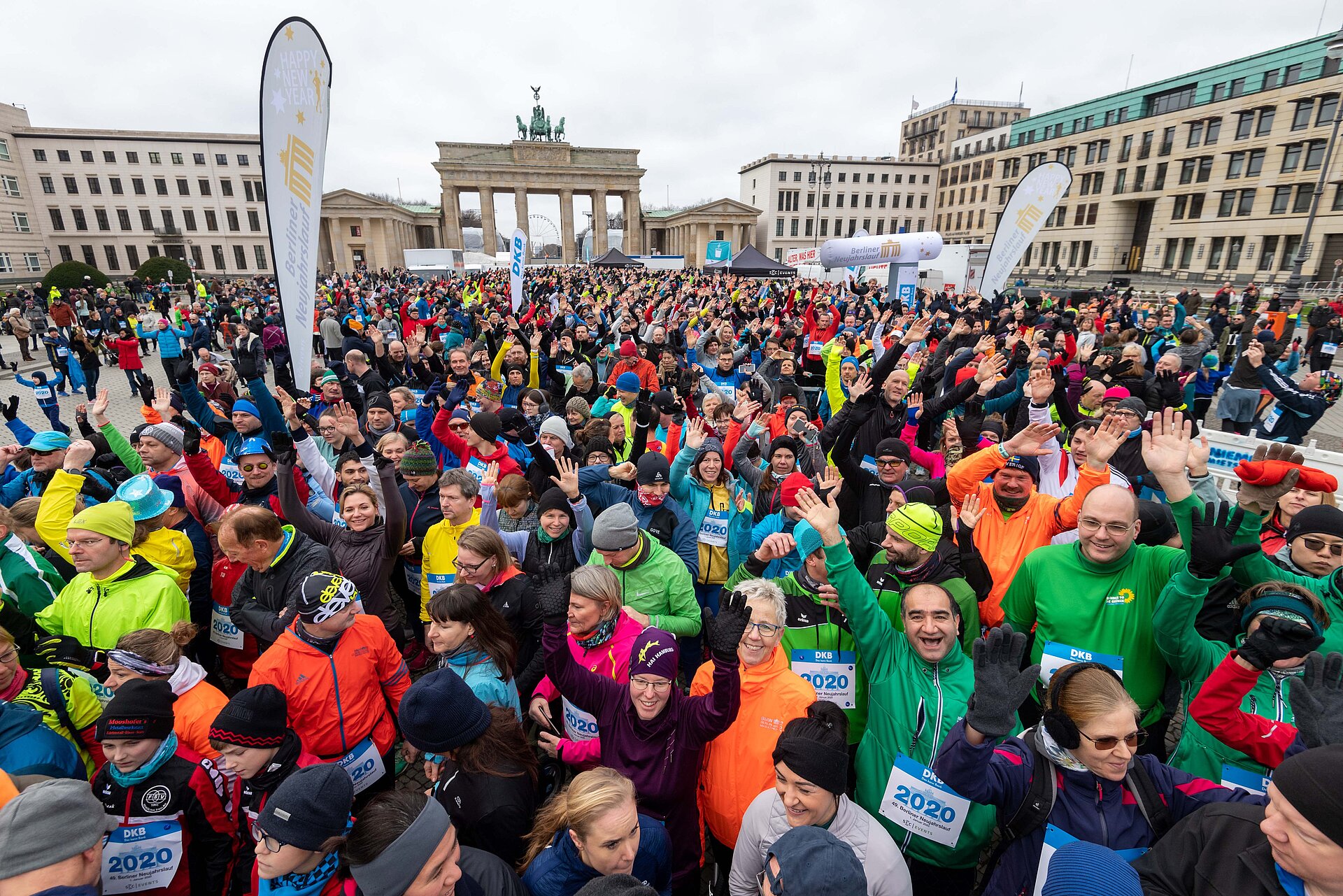 Berliner Neujahrslauf 2020: Teilnehmer sammeln sich am Start vor dem Brandenburger Tor und winken in die Kamera © SCC EVENTS / camera4